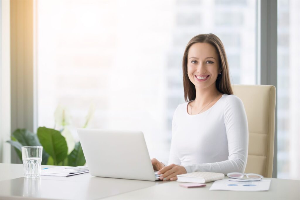 An advisor working at a desk with a laptop