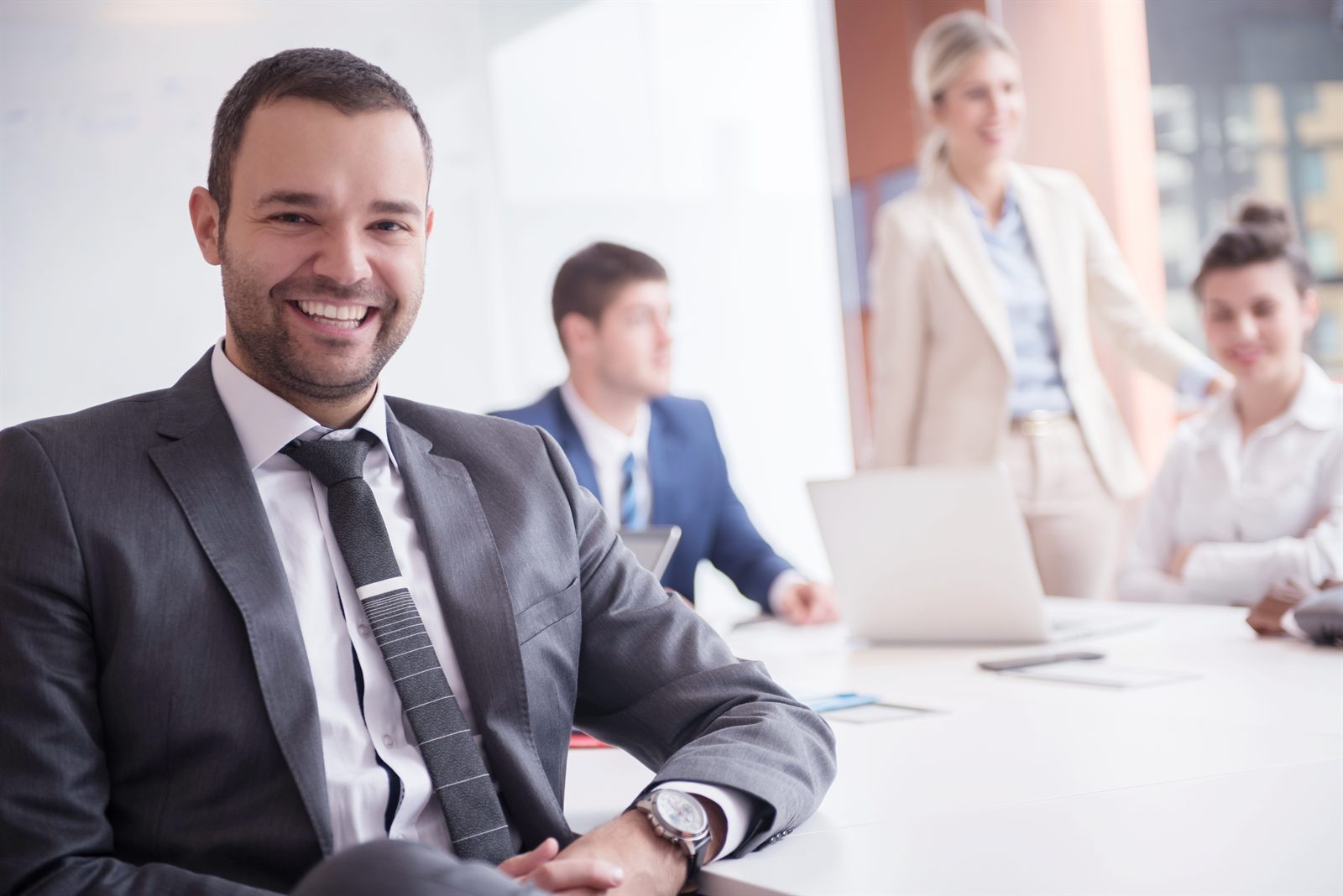 An advisor presenting to clients over a laptop