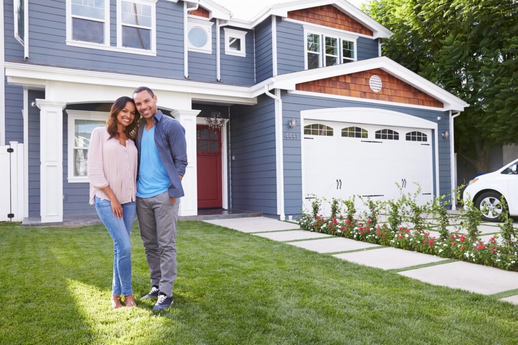 Couple standing outside their home