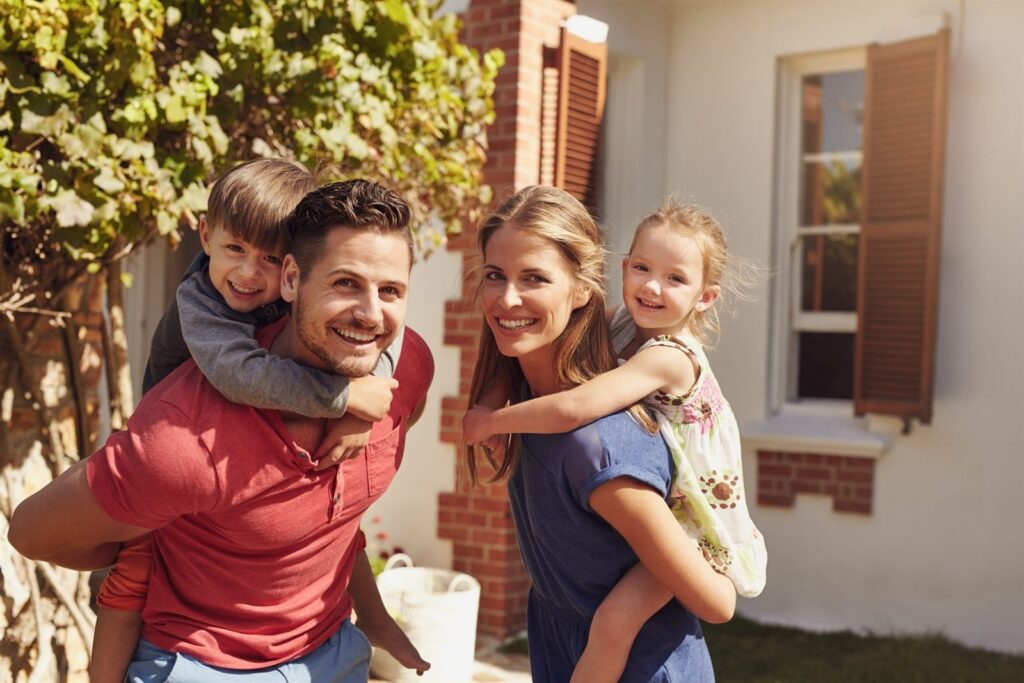 Parents carrying their children and laughing