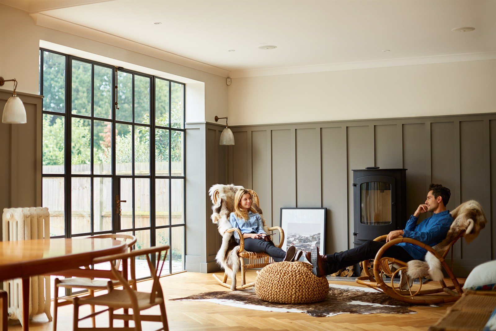 A renovated open-plan living room with large windows