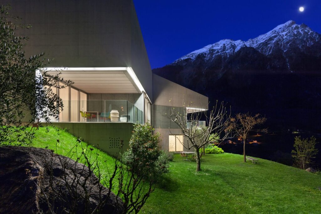 Modern architect designed home lit at dusk