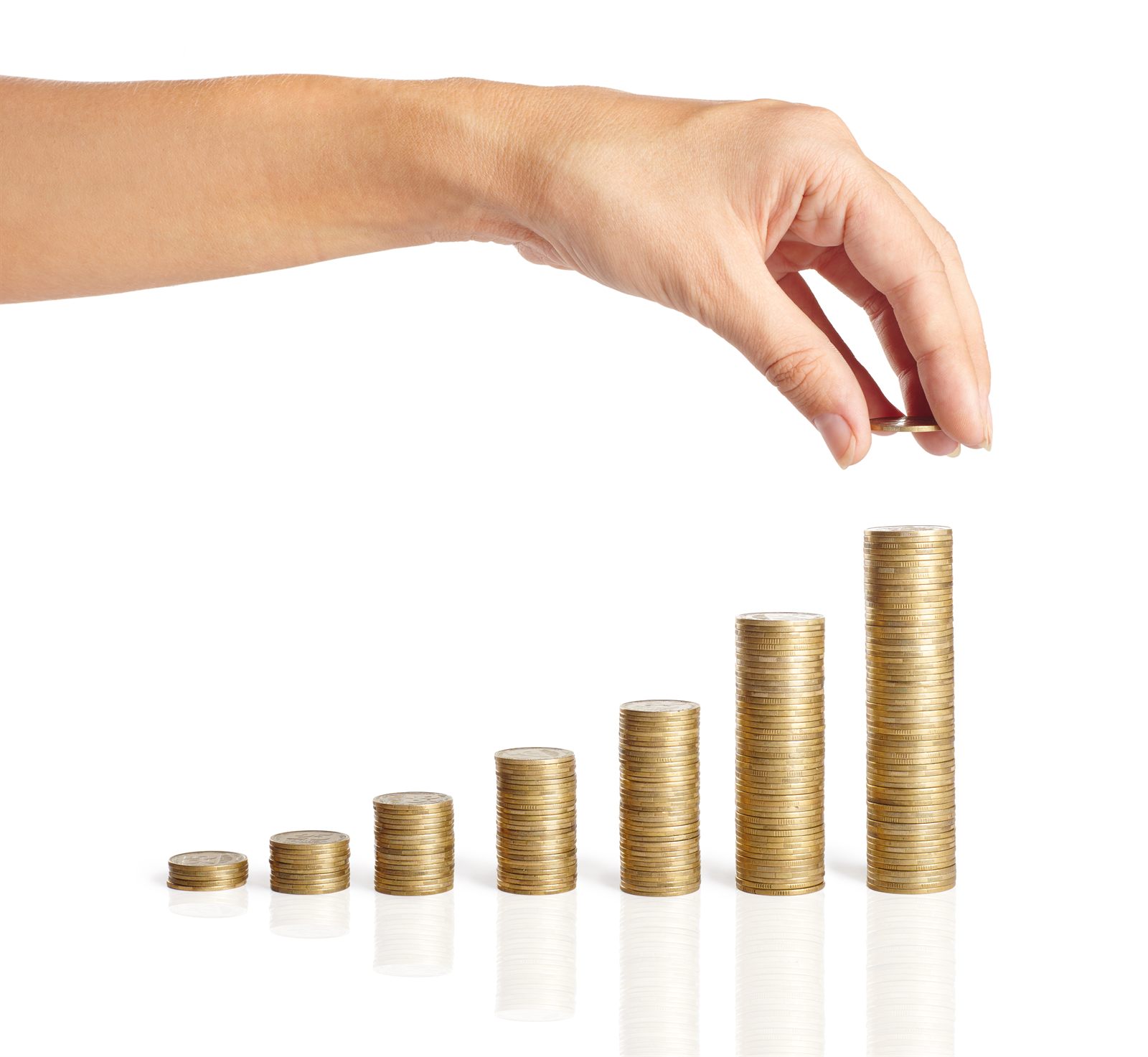 Hand stacking coins to save for a down payment