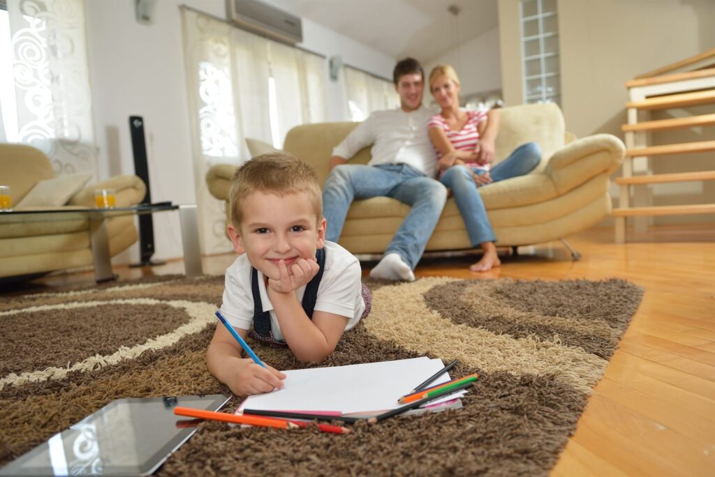 Family with young children relaxing at home