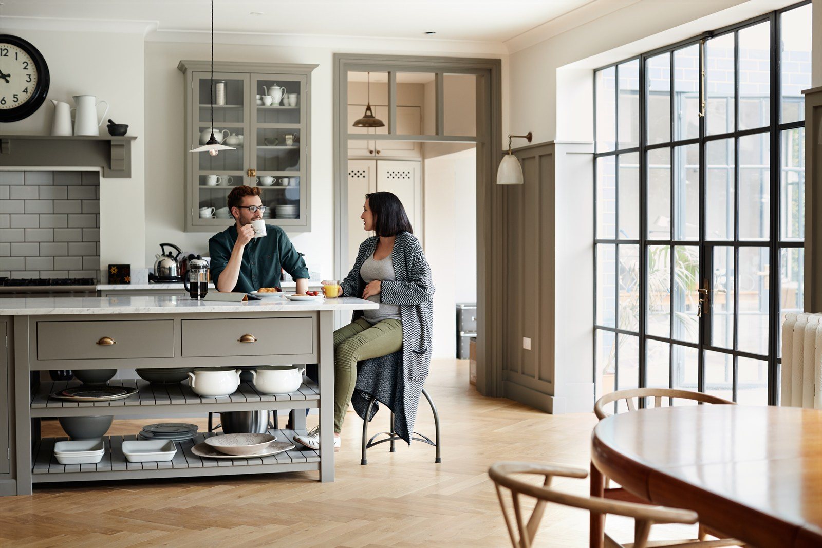 A newly renovated kitchen with a couple at the island