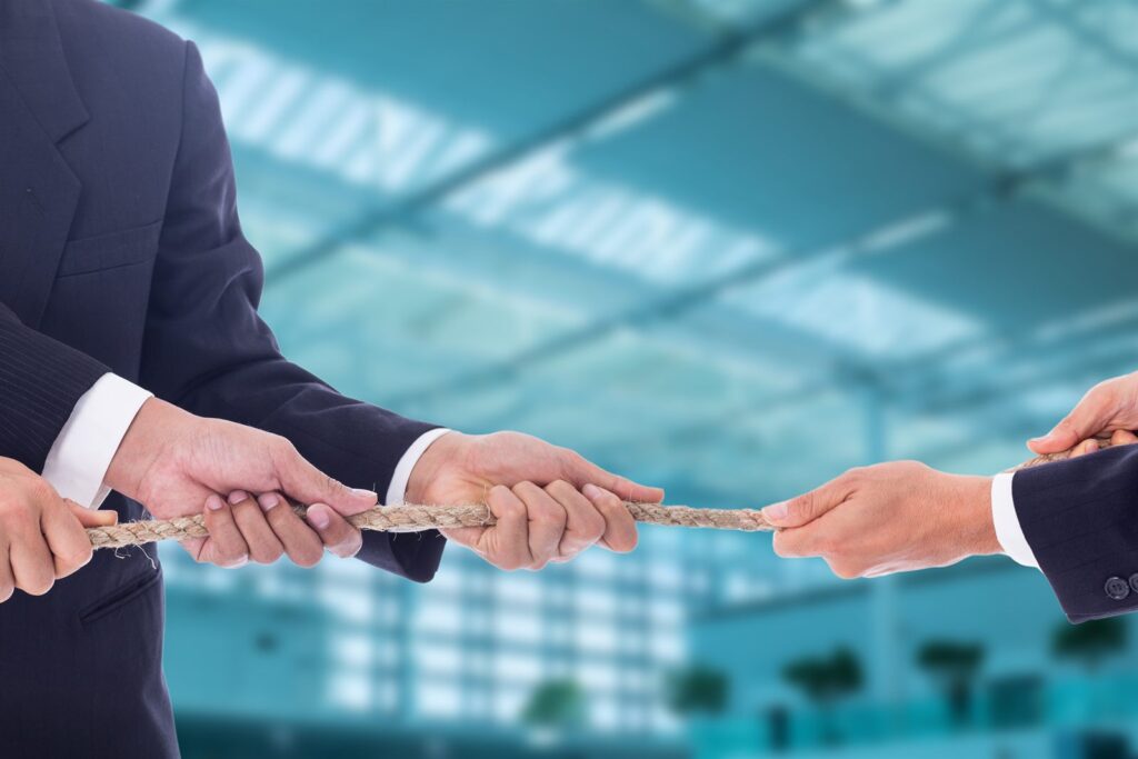 A document passed between two people in business dress
