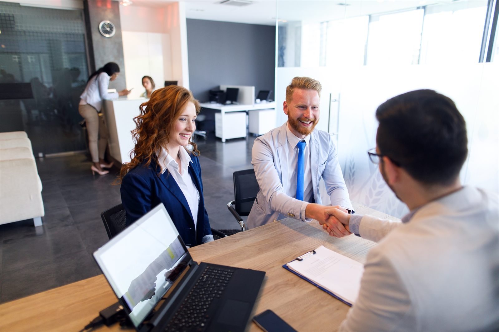 Handshake across a desk in an office meeting