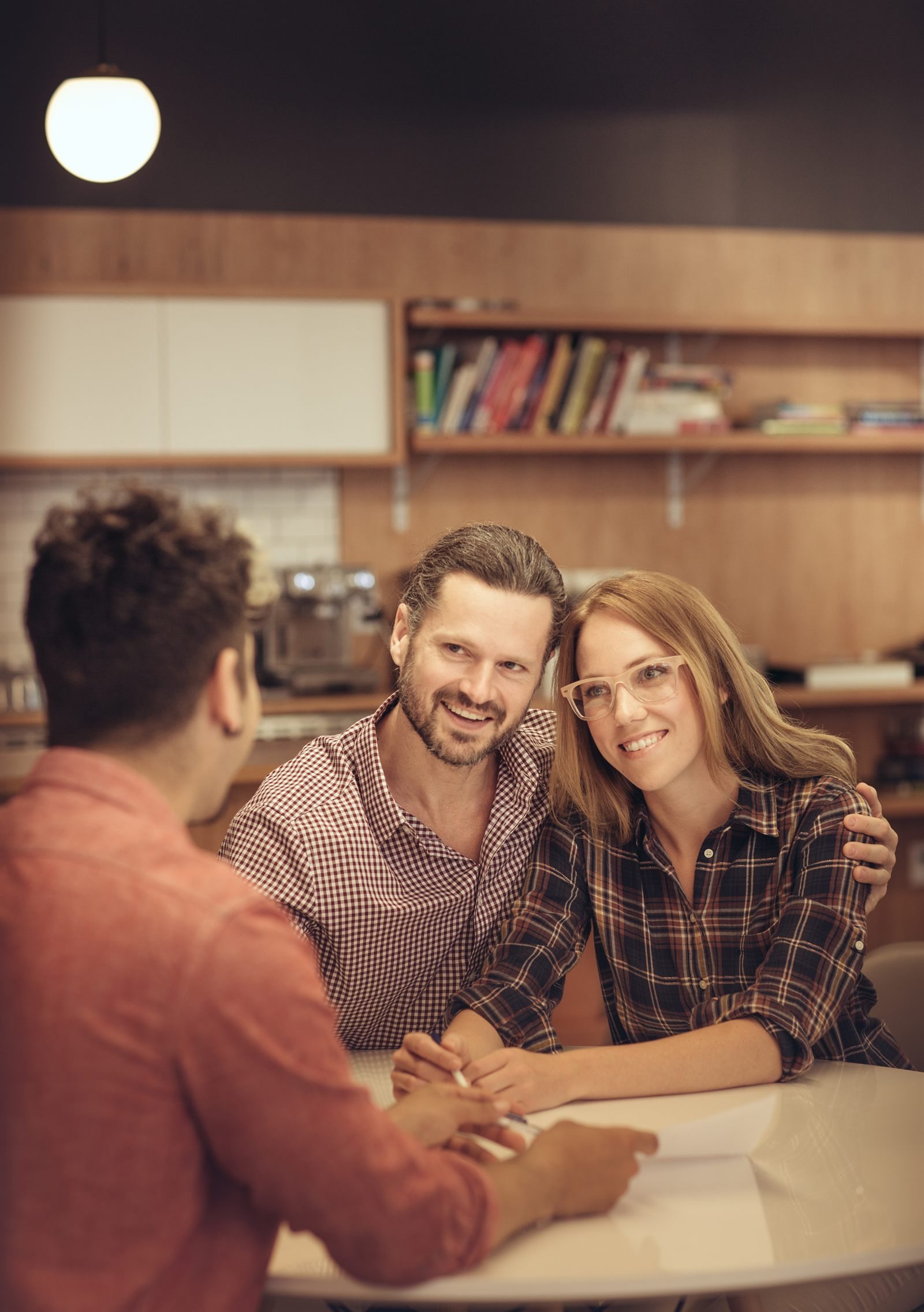 Couple sitting with an advisor reviewing paperwork