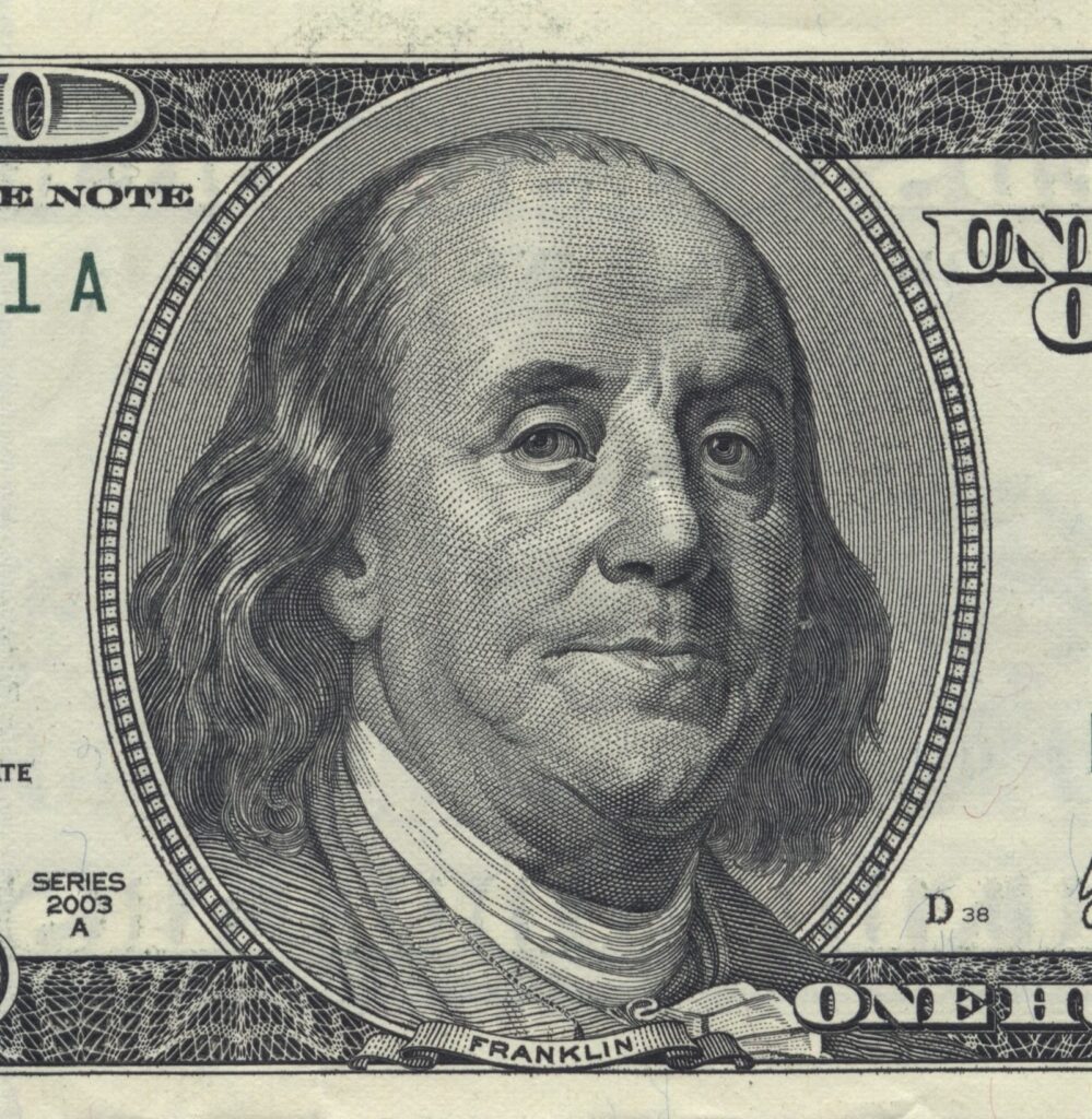 Close-up detail of a one hundred dollar bill