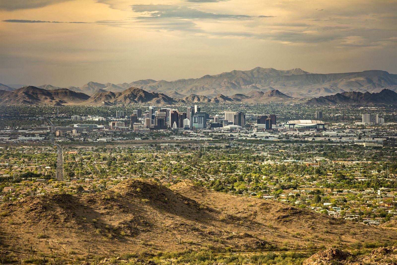 Aerial view of a desert city with mountains on the horizon