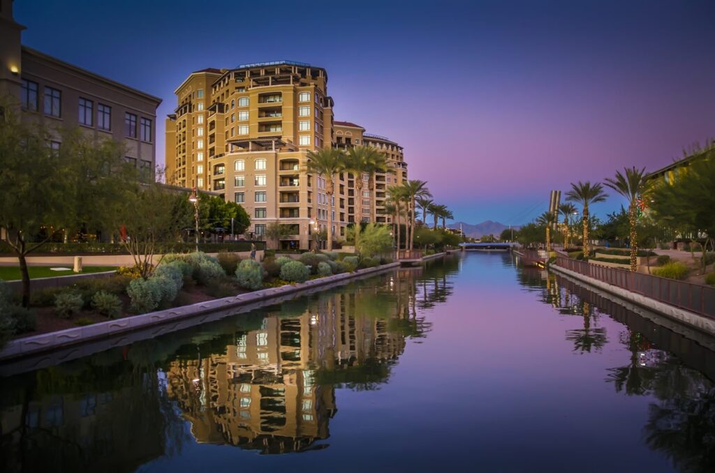 Waterfront buildings reflected in a canal at dusk