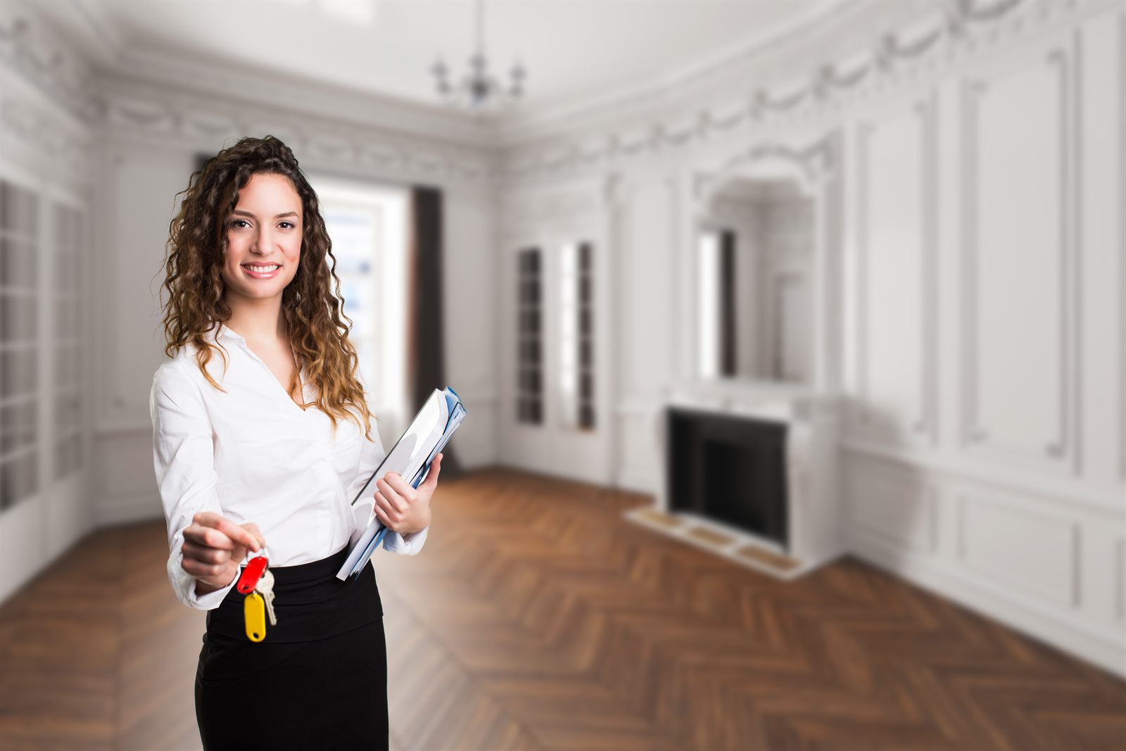 A professional with a clipboard inspecting an empty room