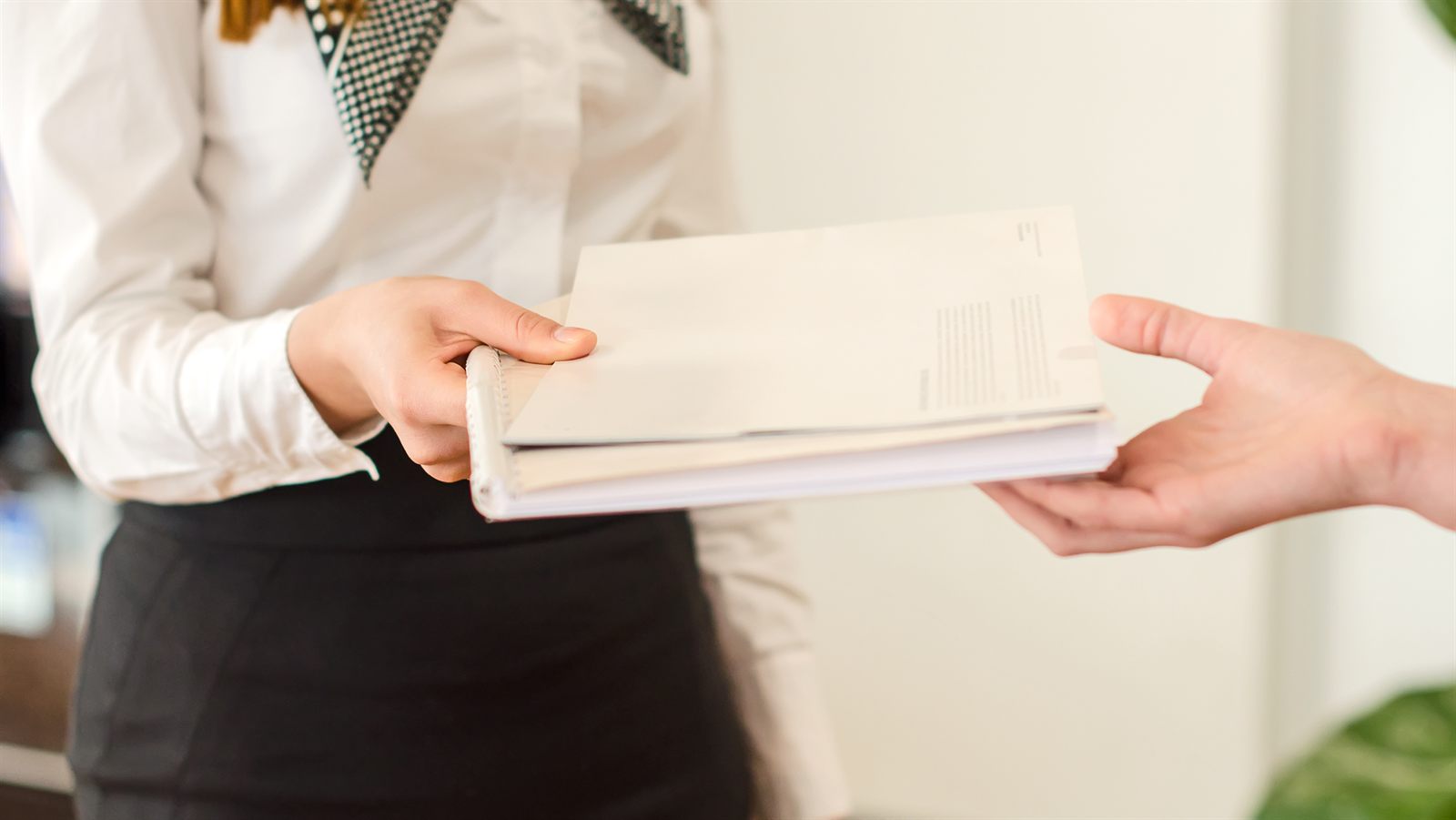 Hands reviewing loan documents