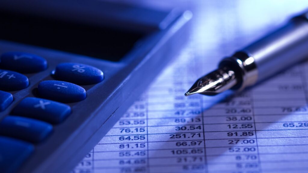 A calculator and interest rate spreadsheet used to compare mortgage rates and APR