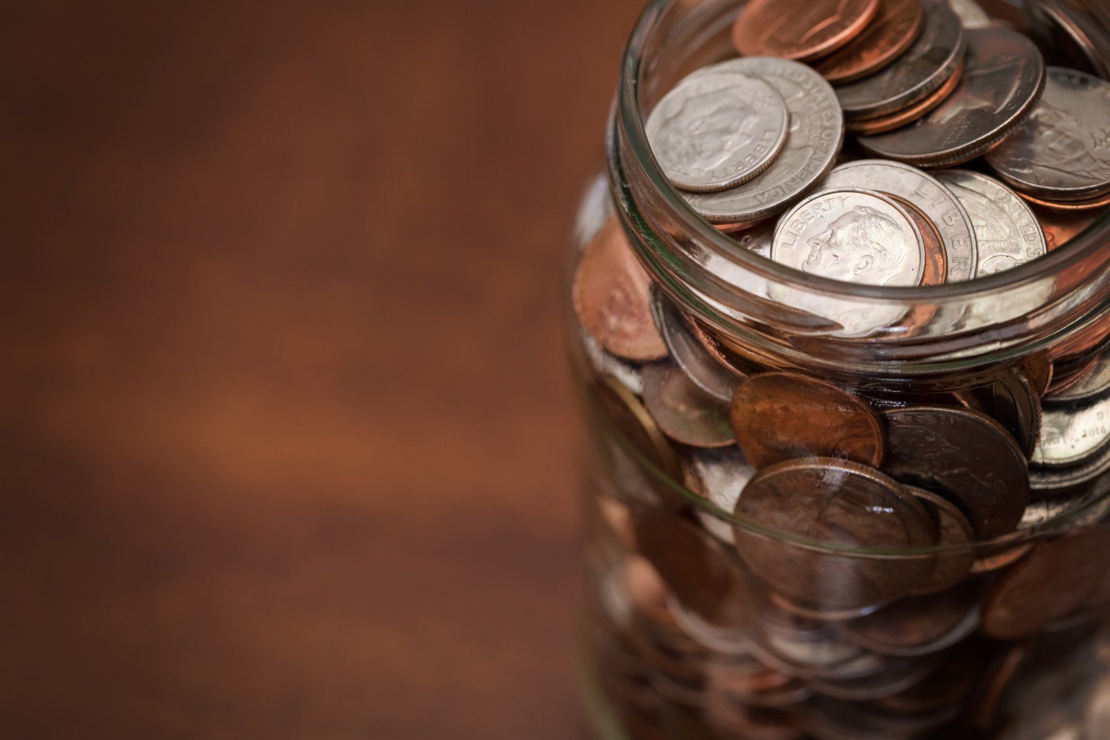 A jar filled with coins, representing savings accumulating over time