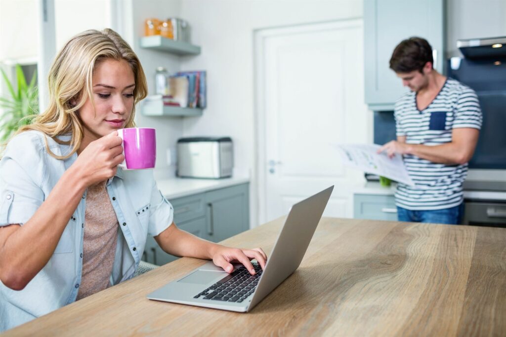 Couple looking at a laptop together at home