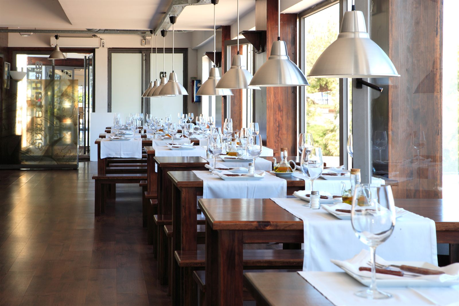The dining room of a modern restaurant with tables laid out