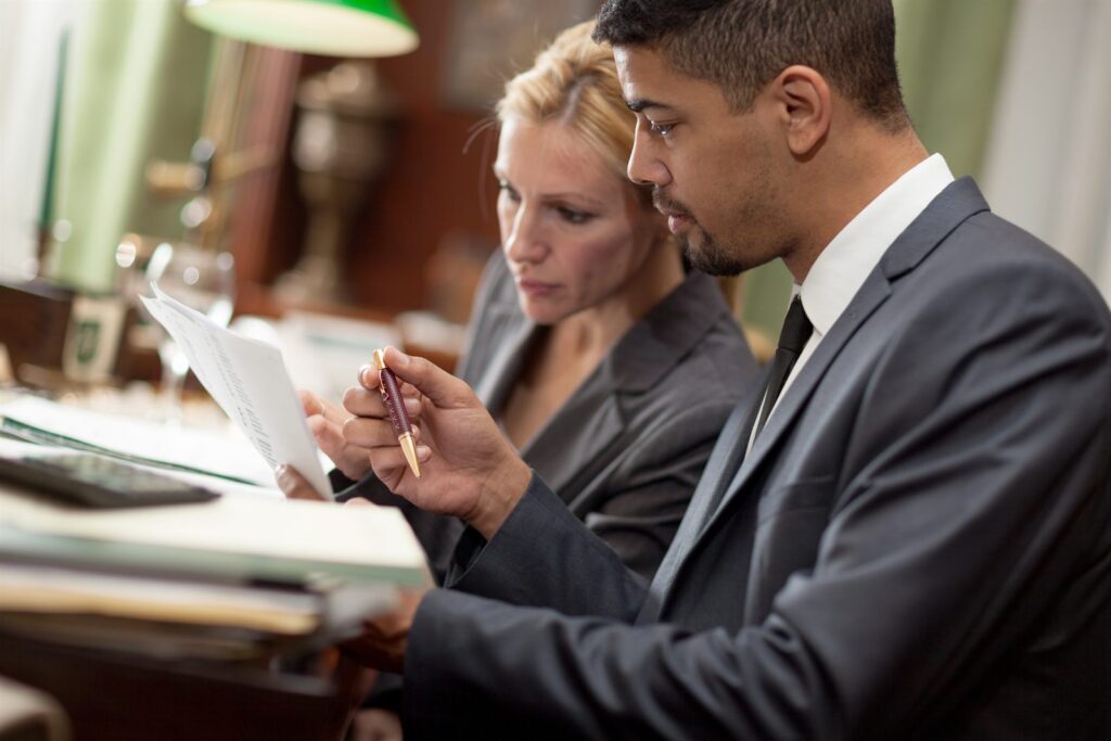 Two professionals reviewing something on a tablet together