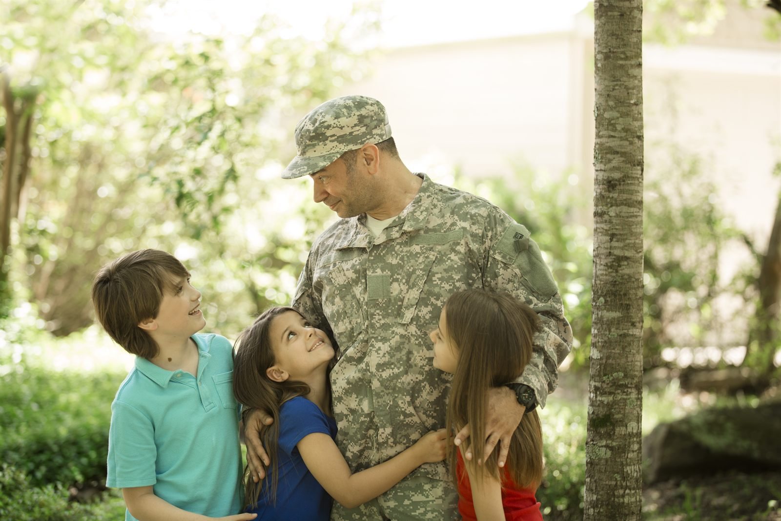 Service member in uniform with their children