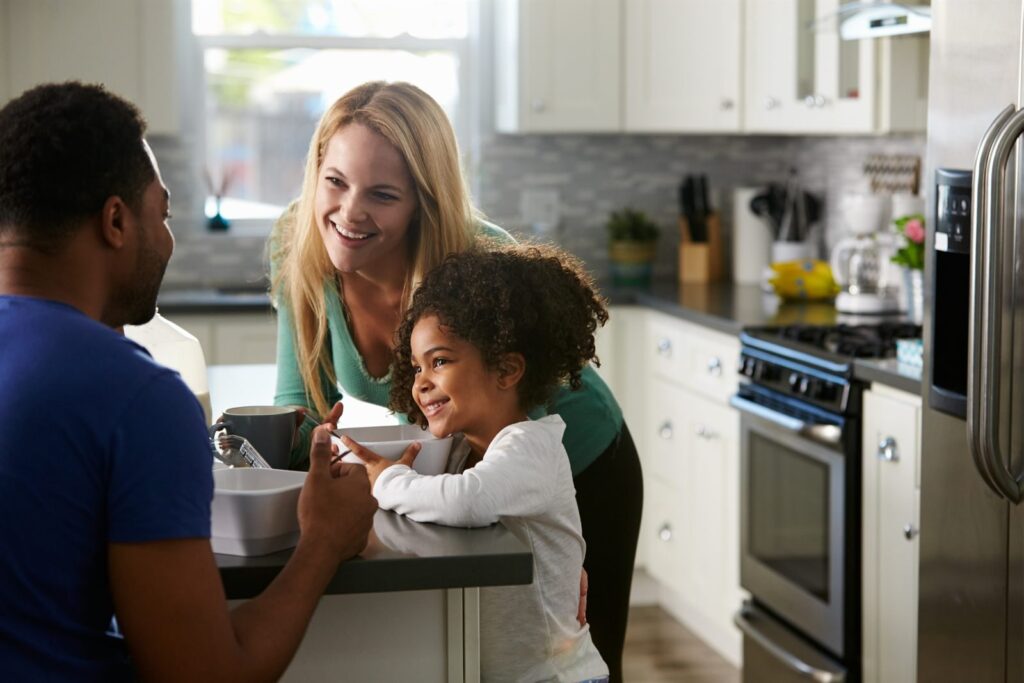 Couple with their daughter at home