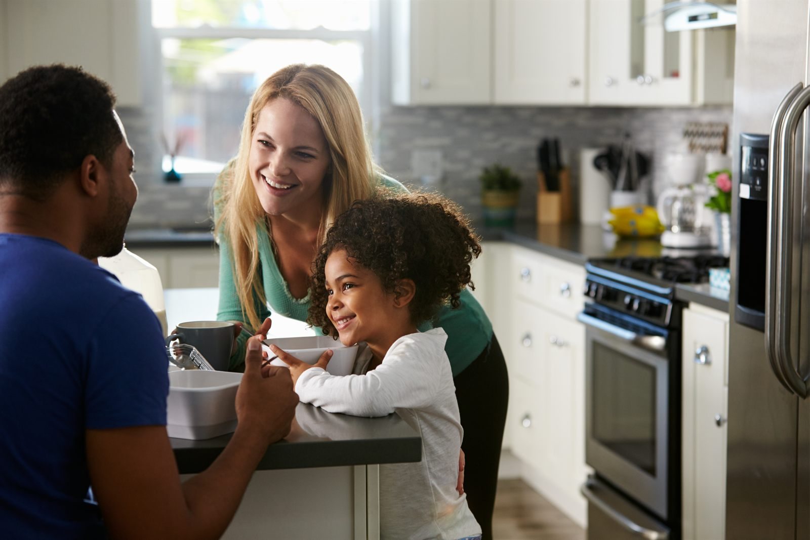 Couple with their daughter at home